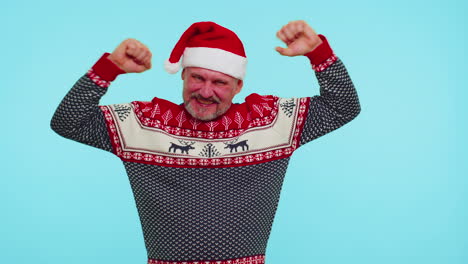 Cheerful-man-in-sweater-Christmas-Santa-shouting,-celebrating-success,-winning,-goal-achievemen