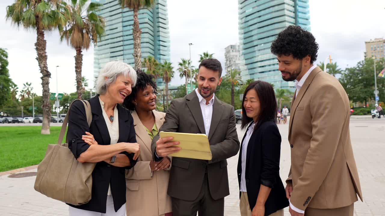 Business team looking at a tablet outdoors