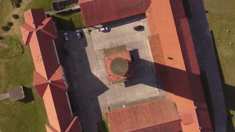 Aerial-top-down-shot-of-Old-Hotel-and-tower-lighting-in-sun---Chapadmalal-in-Argentina