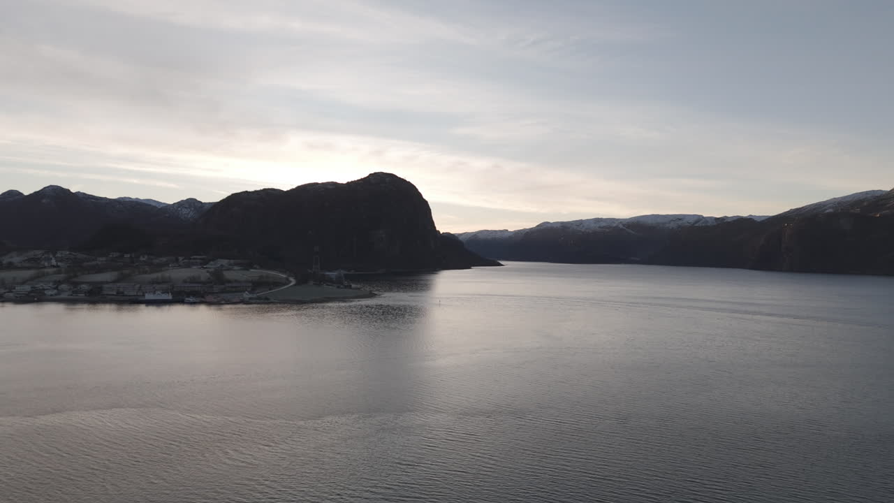 Drone shot flying over the water near Forsand Norway Lysefjord during sunset on a clear day LOG
