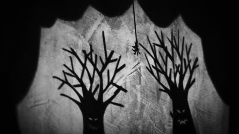spooky shadow puppets of trees and a spider