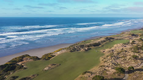 golfers play on bandon dunes golf course next to the pacific ocean