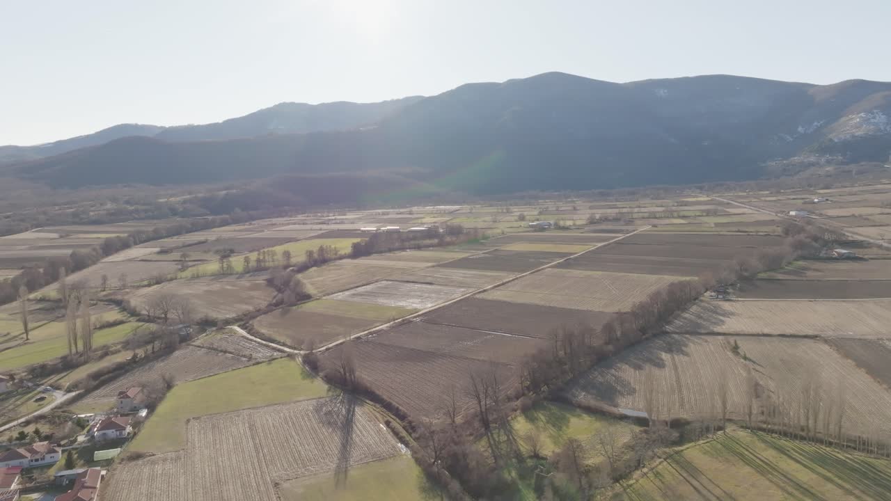 Frontal tracking shot of an agricultural area with mountains in the background in the area of ​​the city of Sklithro, Florina, Greece.