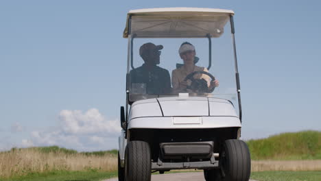 caucasian woman and african american man on the golf course.