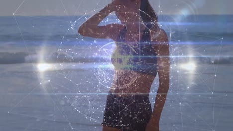 Animation-of-data-processing-and-globe-over-caucasian-woman-at-beach