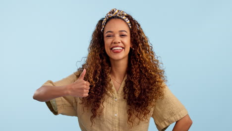 Face,-happy-and-thumbs-up-of-woman-in-studio