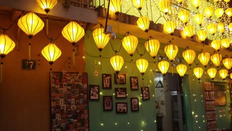 illuminated street with yellow lanterns at night in hoi an, vietnam