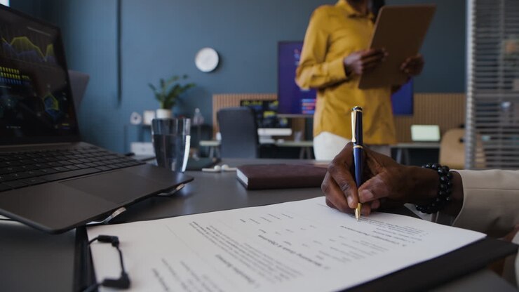 Businesswoman Signing a Contract in the Office