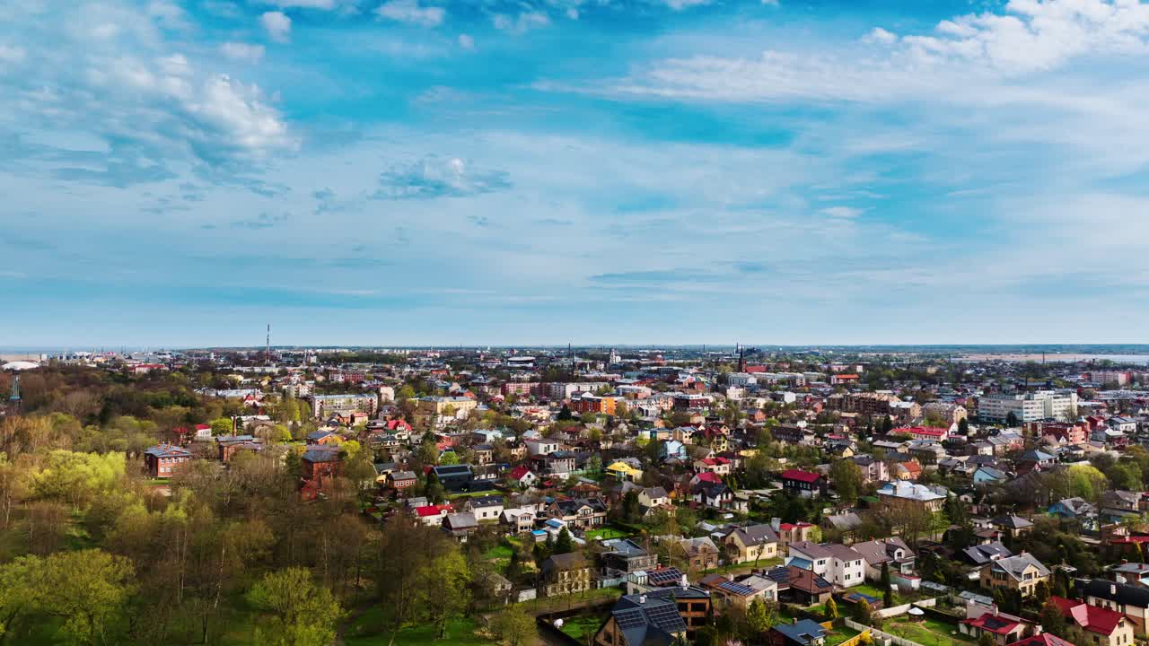 Liepāja neighborhood time-lapse with scenic horizon and vibrant home colors, 4K