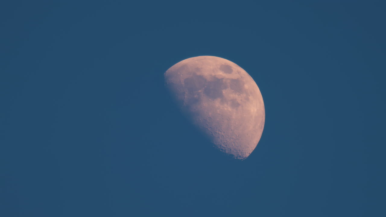 View of a half-moon on the blue sky