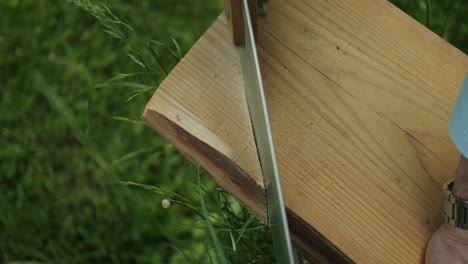 Close-up-top-shot-of-a-man-working-with-a-handsaw