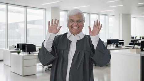 happy indian senior lawyer waving and saying hello