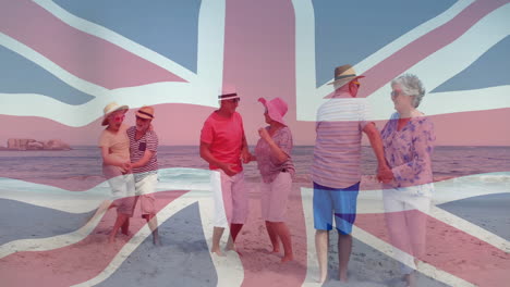 animación de bandera de la unión sobre un grupo de ancianos bailando en la playa