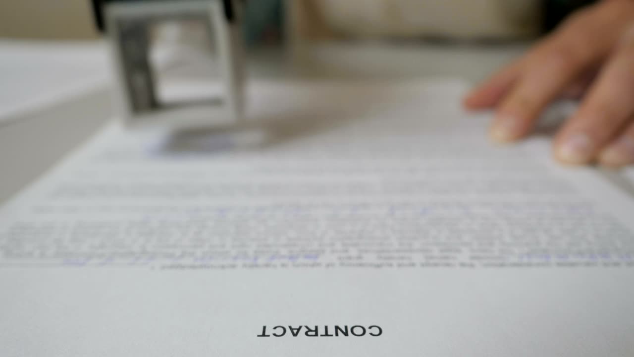 Notary public in office stamping document. Businessman stamping document table, director approving contract, paperwork. Man is approve documents by signing and stamping papers. Closeup. UHD 4K.