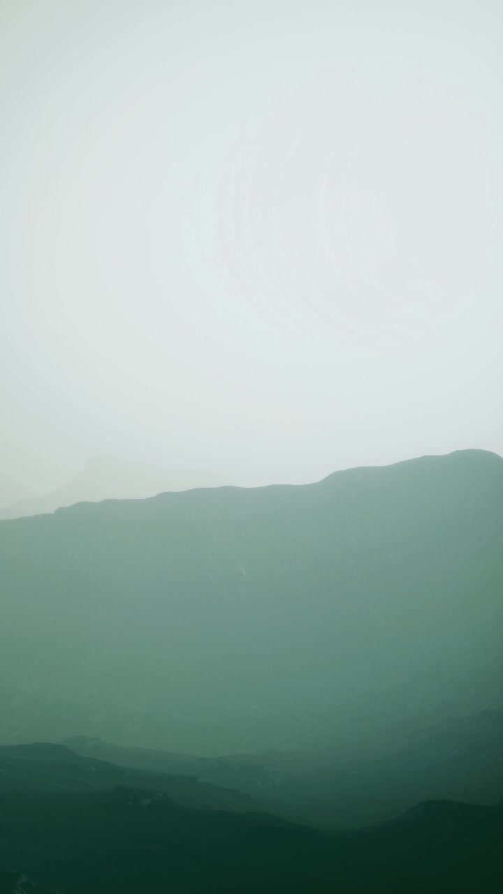 Fog covers mountains during early morning hours in a remote location
