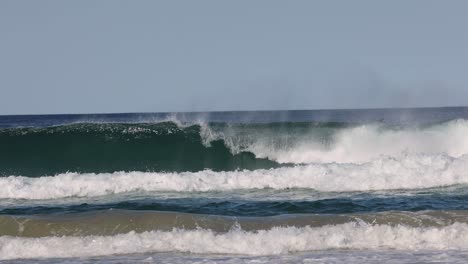 sequence of a surfer catching and riding a wave