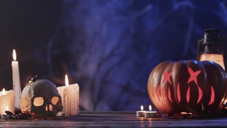 Video-of-halloween-carved-pumpkin,-skull,-candles-and-smoke-with-copy-space-on-purple-background