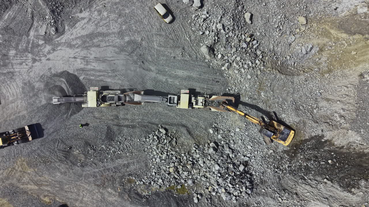 Granite quarry operation showing heavy machinery and equipment during the extraction process