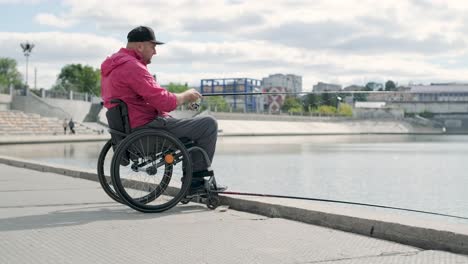 person with a physical disability who uses wheelchair fishing from fishing pier