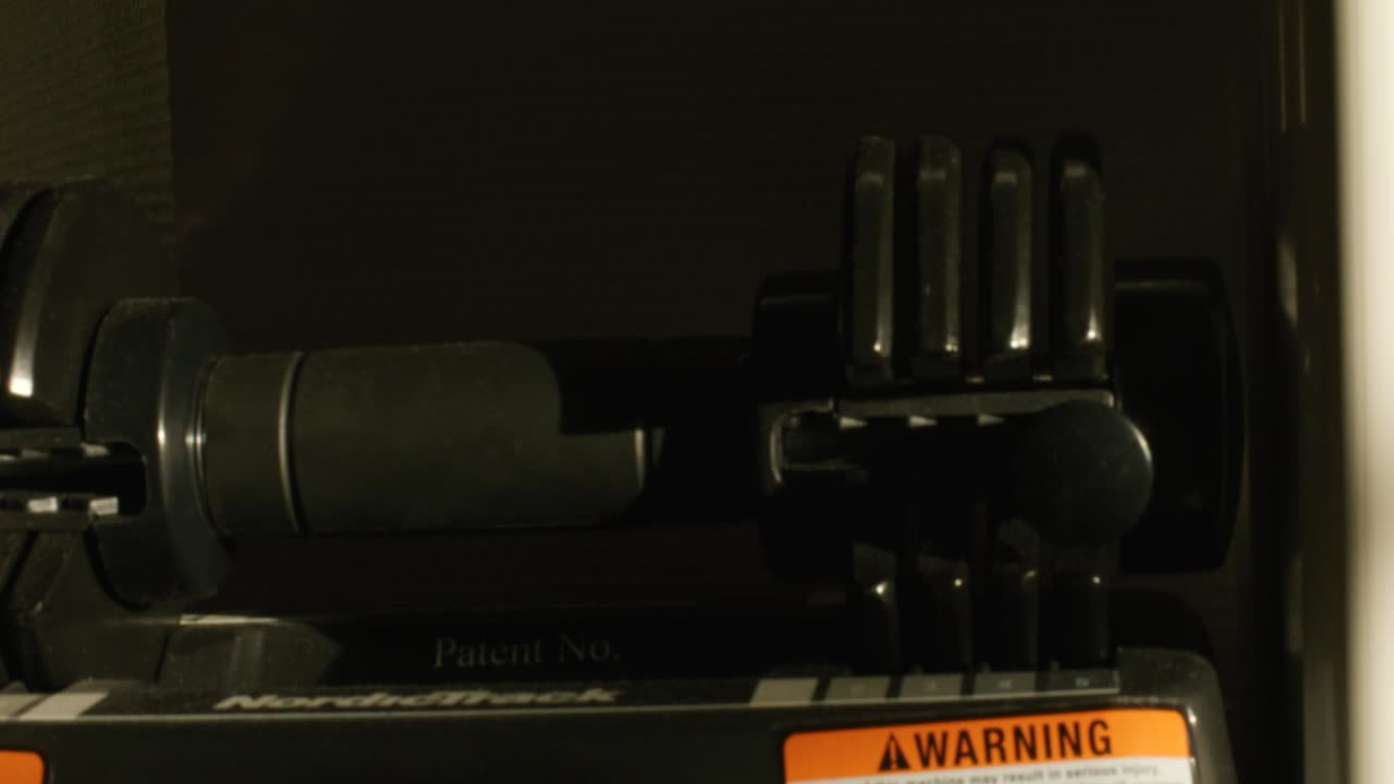 Dumbbell weights sitting on rack in home workout gym at sunset