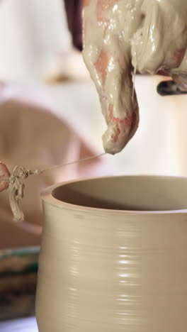 mid section of potter making pot