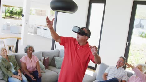 happy senior diverse people using vr headset at retirement home