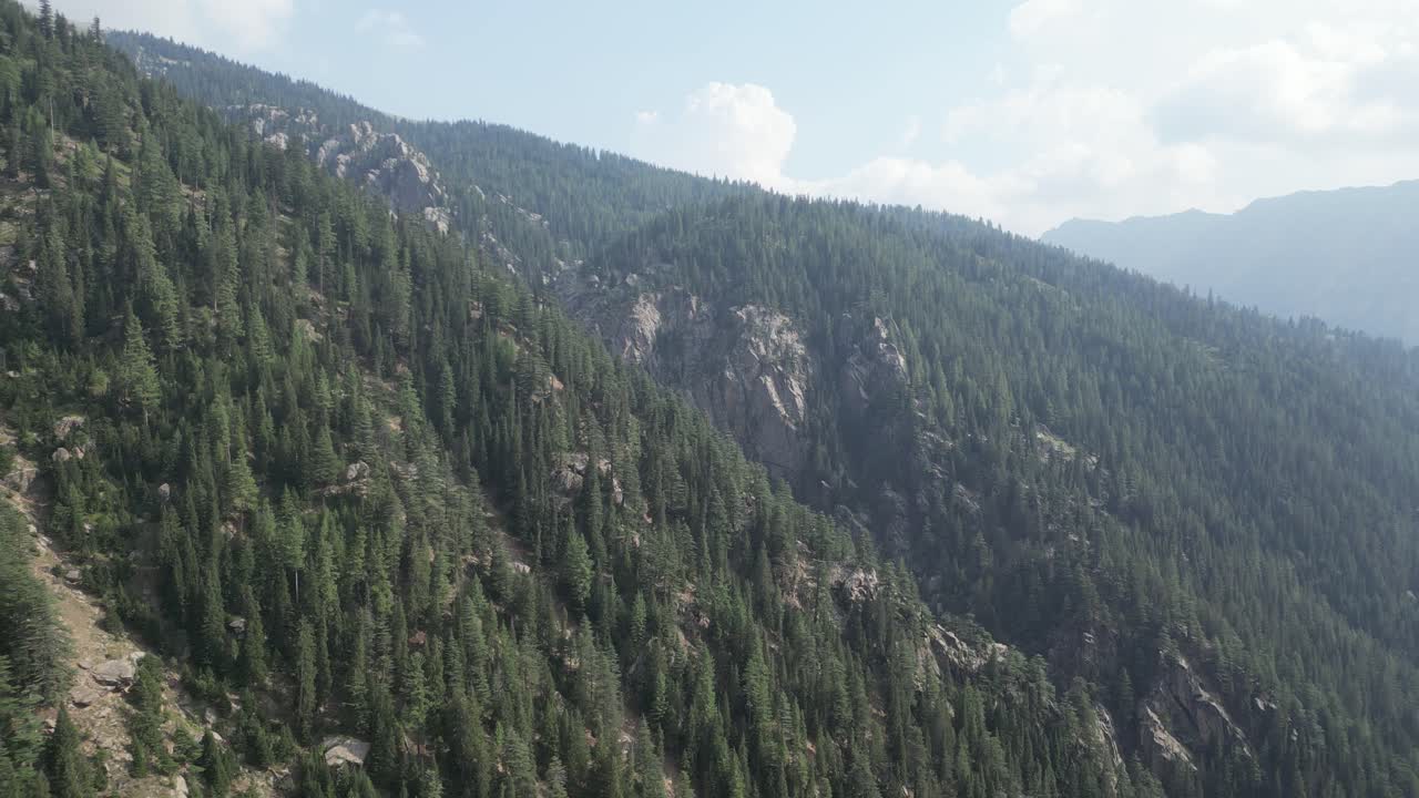 Afghanistan Hindu Kush Drone Aerial view approaching vast mountains and forests in Nangahar Nuristan