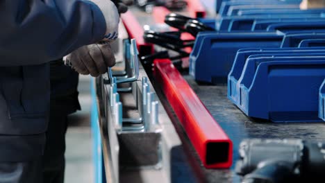 Human-hands-insert-threaded-metal-parts-into-unit-during-manual-assembly