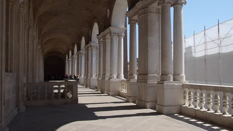 long colonnade of pillars and arches in italy
