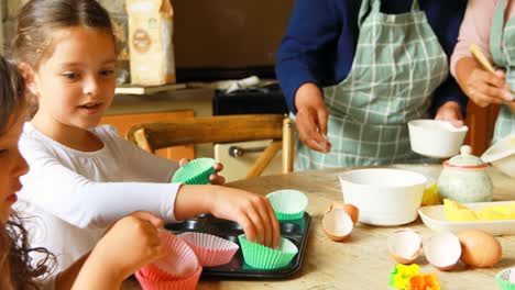 Siblings-preparing-food-with-family-in-kitchen-4k