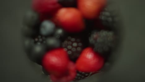 various berries fill rotating glass container