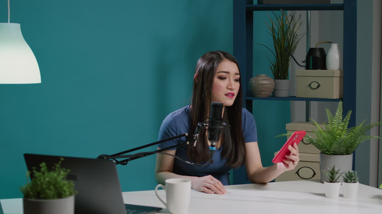 Asian influencer recording live podcast and reading comments