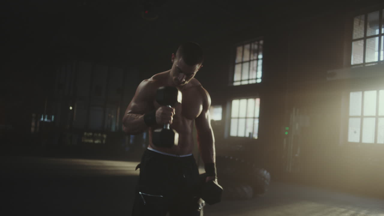 Man working out with dumbbells in a gym