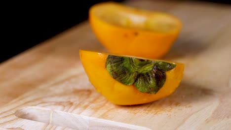 persimmon halves displayed on a cutting board