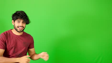 Indian-guy-point-out-with-green-background-indian-guy-standing-on-green-screen---chroma-key