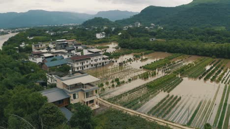 houses and fields heavily damaged from flood water in china, aerial view