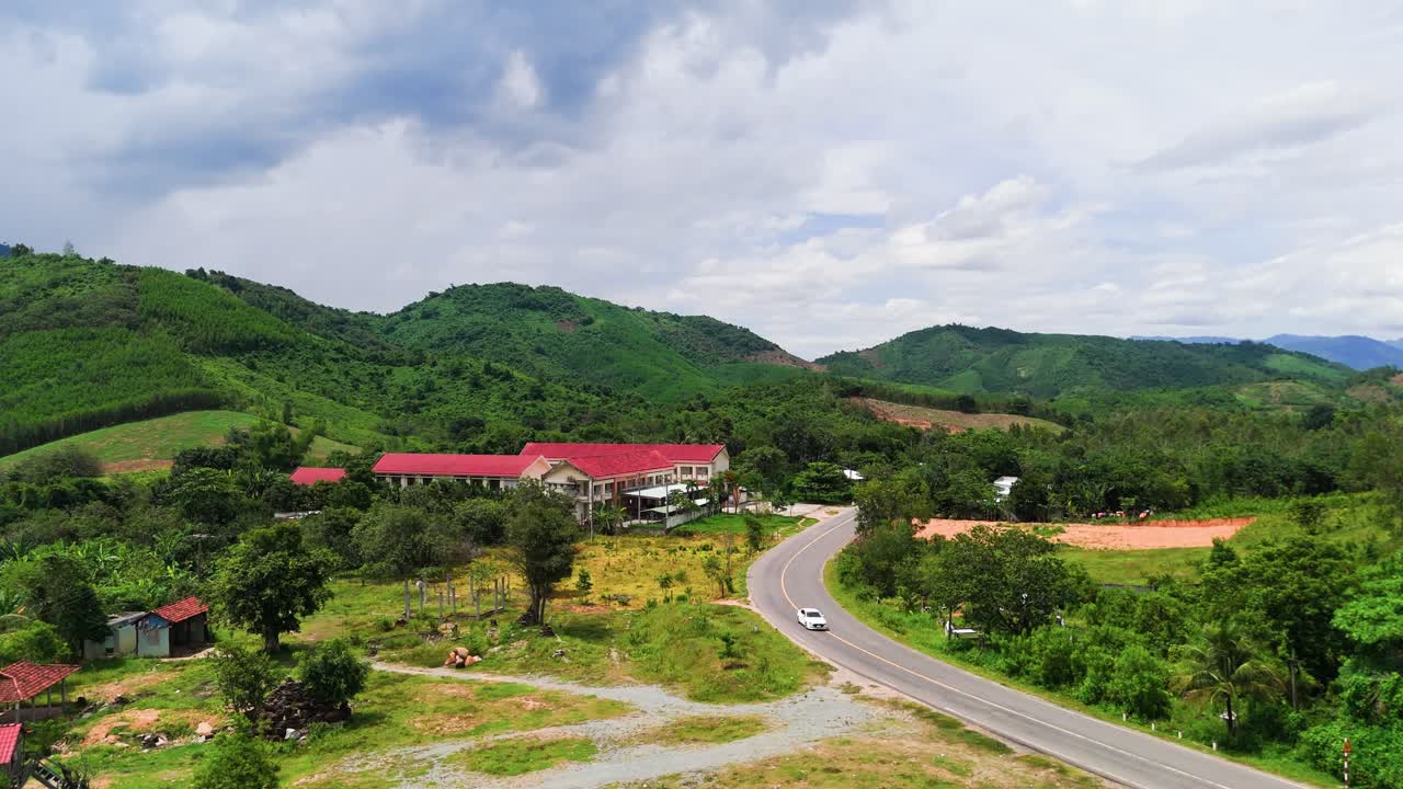 Aerial View Dolly of Cars Driving in the Mountains in Lam Dong