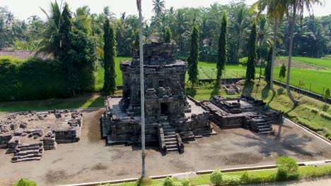 aerial circling shot of ancient buddhist temple ngawen on java, indonesia