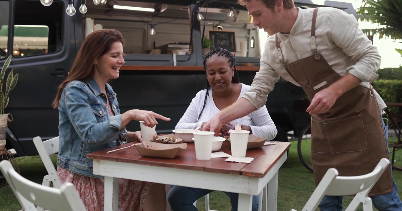 Chef Serving Food to Happy Women at Outdoor Food Truck