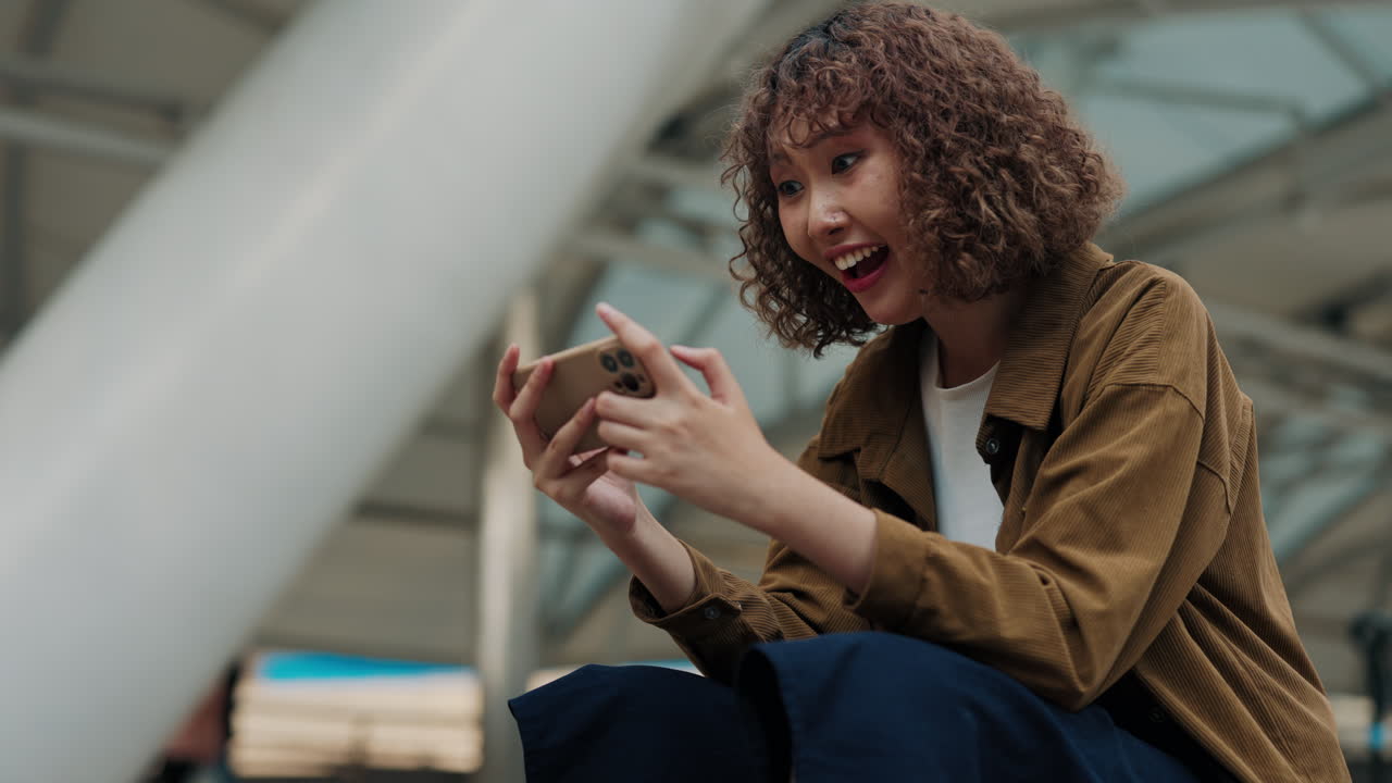 Woman Playing Game on Smartphone, Excited