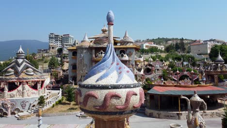 Exterior-Of-The-Colorful-Qasr-el-Ahlam-In-The-Village-Of-Bakhoun-In-Dennieh-Casa---aerial-drone-shot