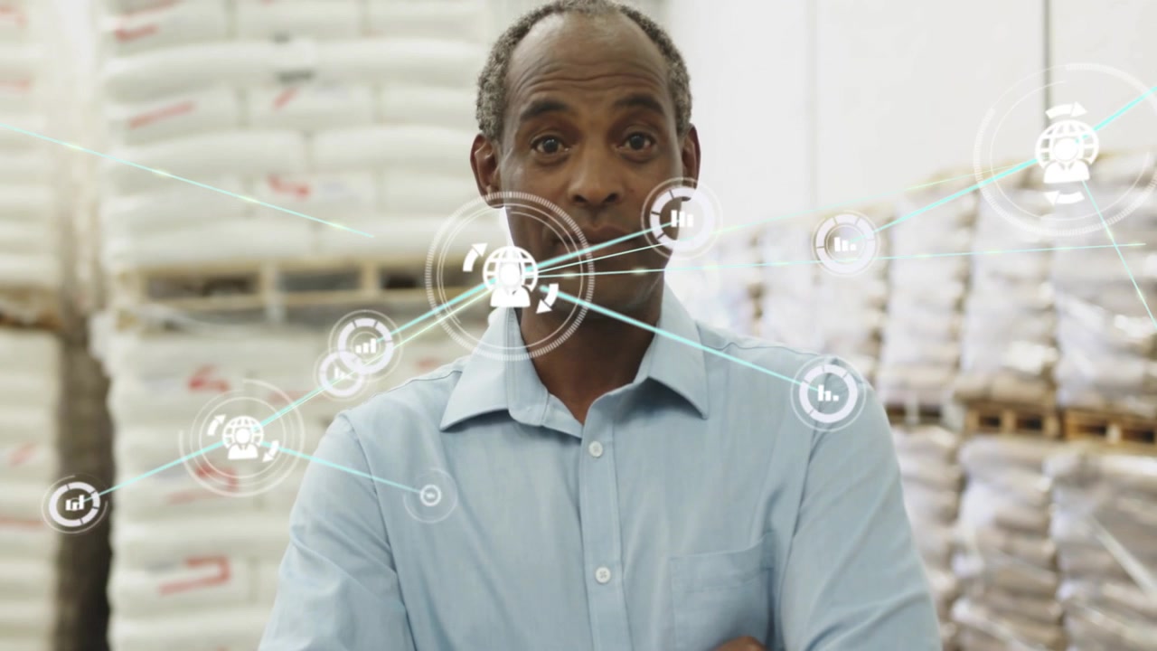 Warehouse manager adjusting cuff, crossing arms, HUD graphics forming network, mapping inventory