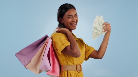 happy woman, money fan and shopping bags