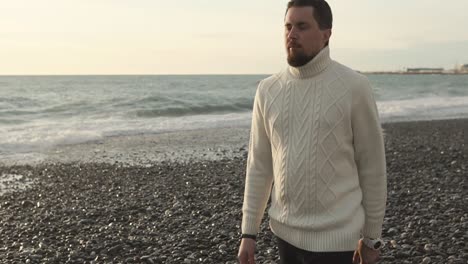 man walking on a beach at sunset