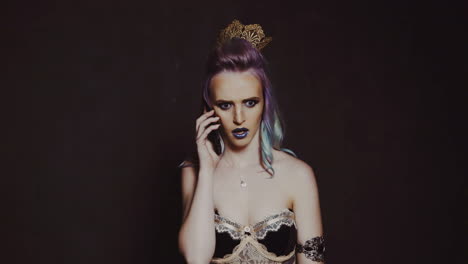 young beautiful woman with smart phone. pretty laughing woman talks on the phone standing on black background