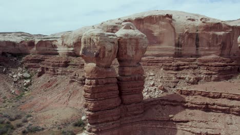 Beautiful-scenic-aerial-view-of-Navajo-Twins-red-rock-formation-landmark-in-Bluff,-Utah,-USA