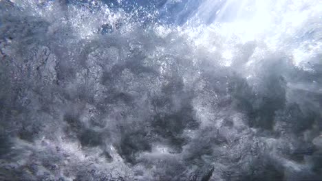 Extreme-Slow-Motion-underwater-view-of-a-shore-break-wave-shot-from-below-the-wave