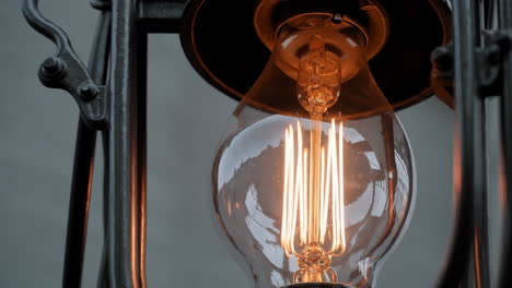 close-up of a vintage edison light bulb with glowing filaments