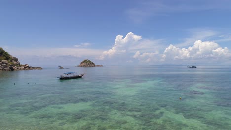 beautiful tropical island with boat and clear water