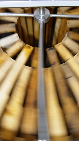 working honey harvesting apparatus. honey frames placed in circle are spinning in the centrifuge machine to extract healthy product. vertical video